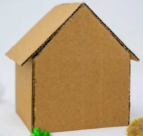 A house made out of pieces of corrugated cardboard